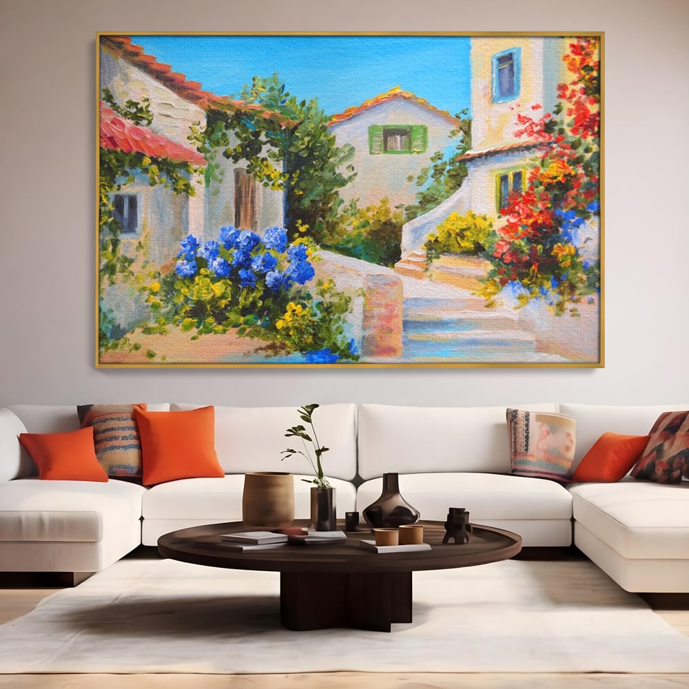 Tablou canvas cu pictura peisaj mediteranean cu case, in rama de aluminiu auriu, pe perete intr-un living