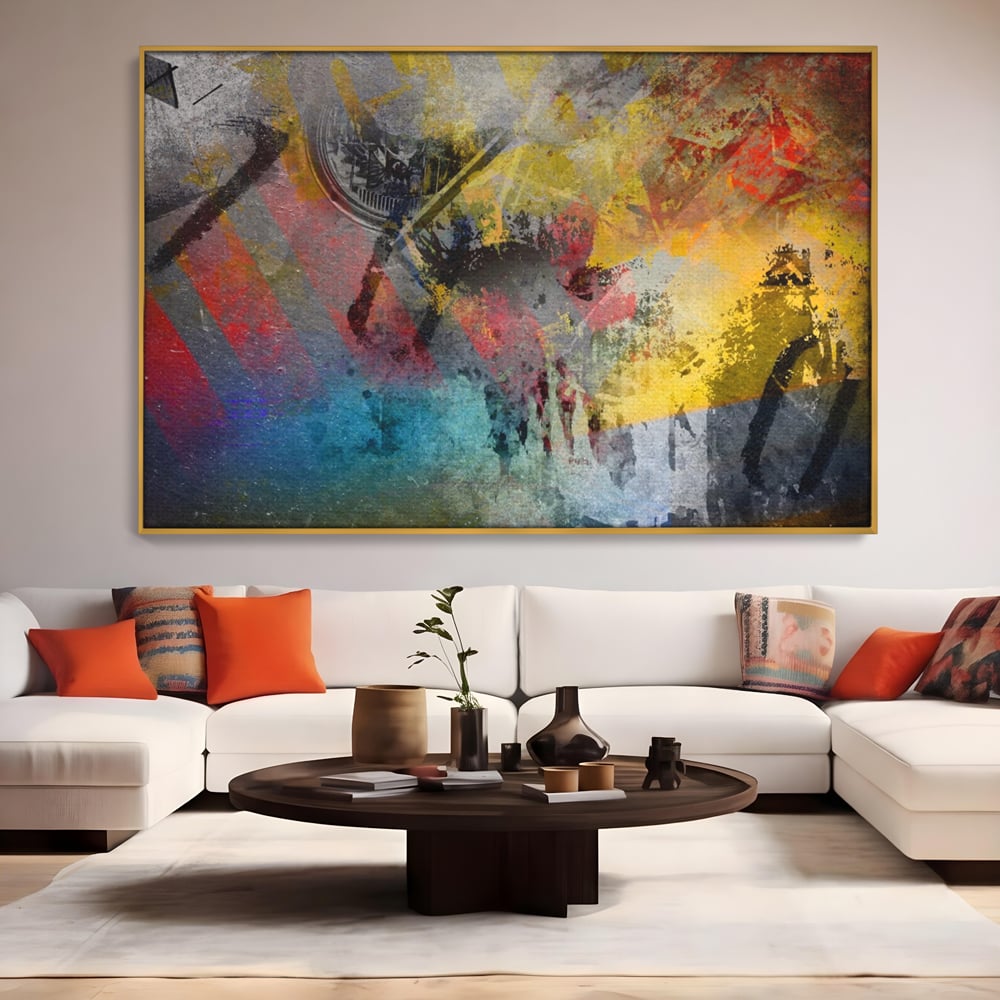 Tablou canvas cu pictura abstracta cu pete vibrante, in rama de aluminiu auriu, pe perete intr-un living