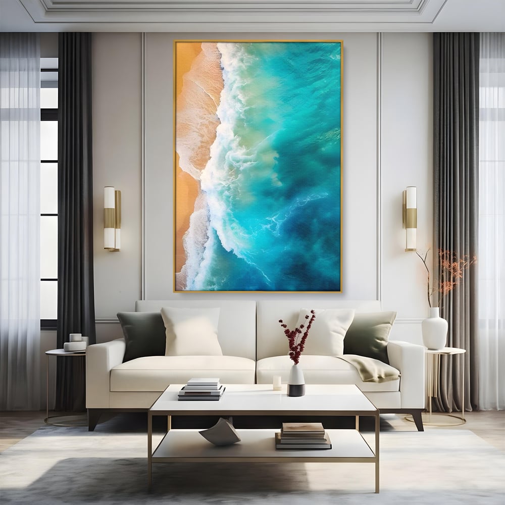 Tablou canvas cu fotografie aeriana cu valuri pe plaja, in rama de aluminiu auriu, pe perete intr-un living