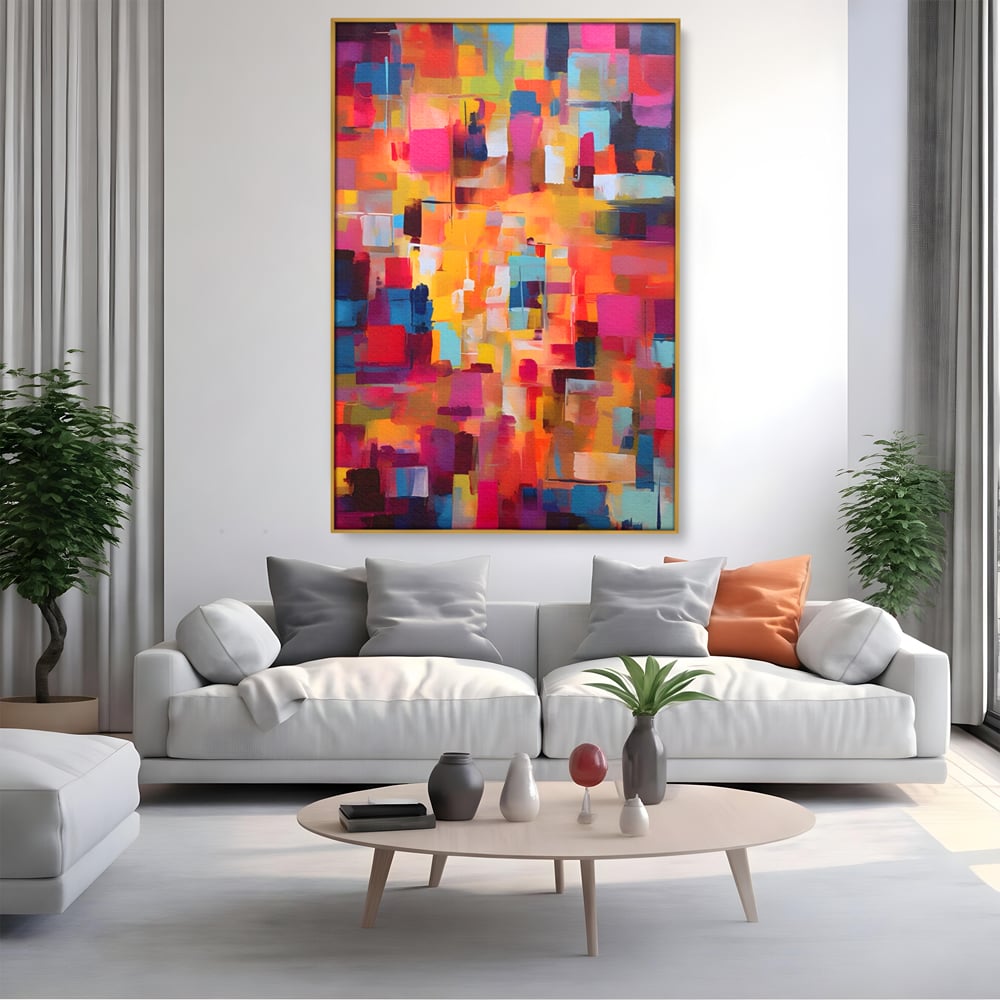 Tablou canvas cu pictura abstracta cu blocuri de culoare, in rama de aluminiu auriu, pe perete intr-un living