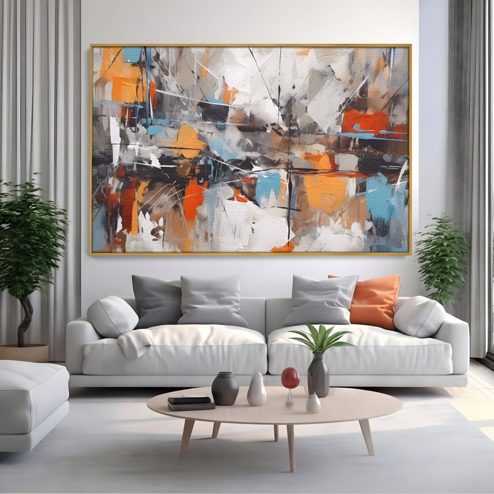 Tablou canvas cu pictura abstracta cu pete portocalii, in rama de aluminiu auriu, pe perete intr-un living