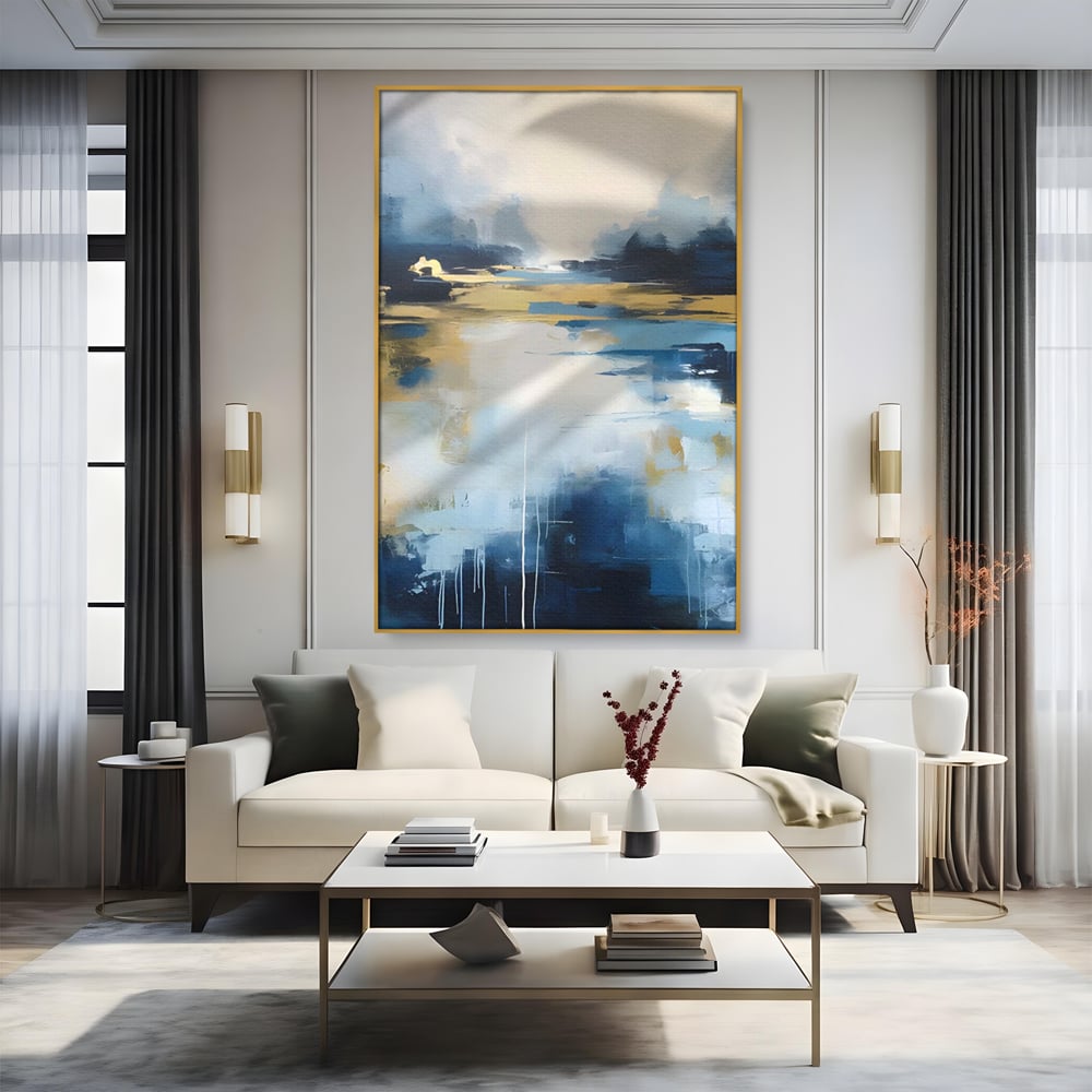 Tablou canvas cu pictura abstracta cu peisaj si cer, in rama de aluminiu auriu, pe perete intr-un living