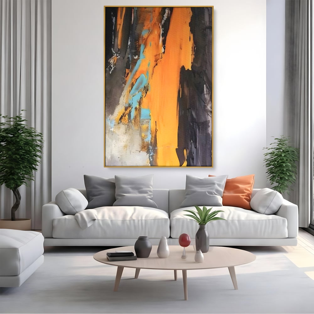 Tablou canvas cu pictura abstracta cu pete portocalii, in rama de aluminiu auriu, pe perete intr-un living