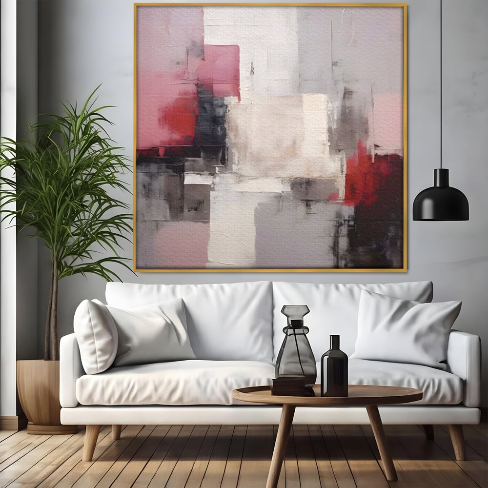 Tablou canvas cu pictura abstracta cu blocuri rosii si negre, in rama de aluminiu auriu, pe perete intr-un living