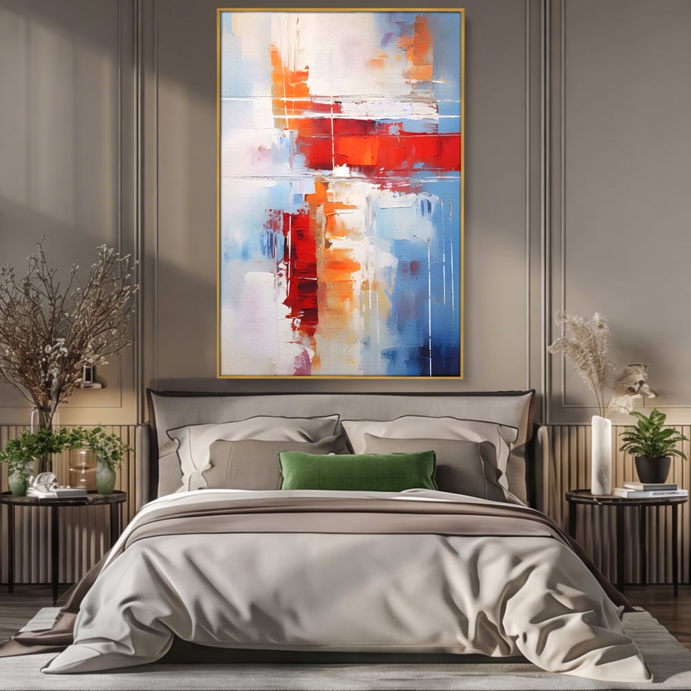 Tablou canvas cu pictura abstracta cu rosu si albastru, in rama de aluminiu auriu, pe perete intr-un dormitor