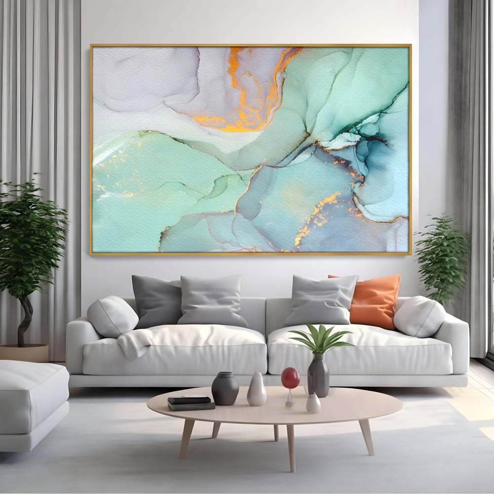 Tablou canvas cu pictura abstracta cu efect de marmura colorata, in rama de aluminiu auriu, pe perete intr-un living