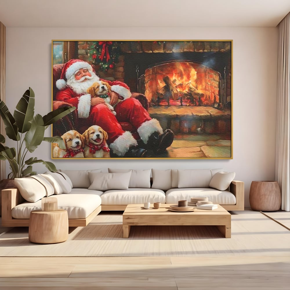 Tablou canvas cu mos craciun dormind cu catei langa semineu, in rama de aluminiu auriu, pe perete intr-un living