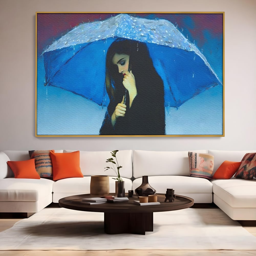 Tablou canvas cu pictura cu femeie sub umbrela albastra, in rama de aluminiu auriu, pe perete intr-un living