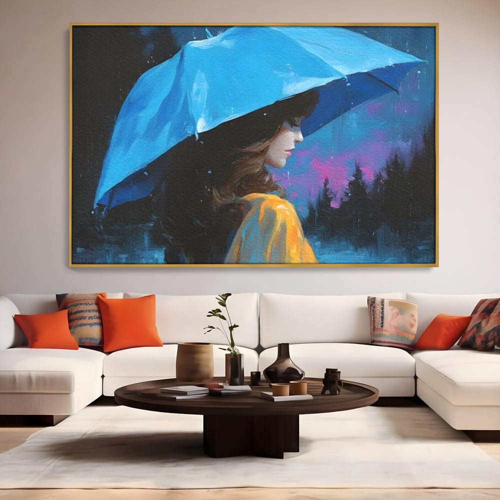 Tablou canvas cu pictura cu femeie sub umbrela albastra, in rama de aluminiu auriu, pe perete intr-un living