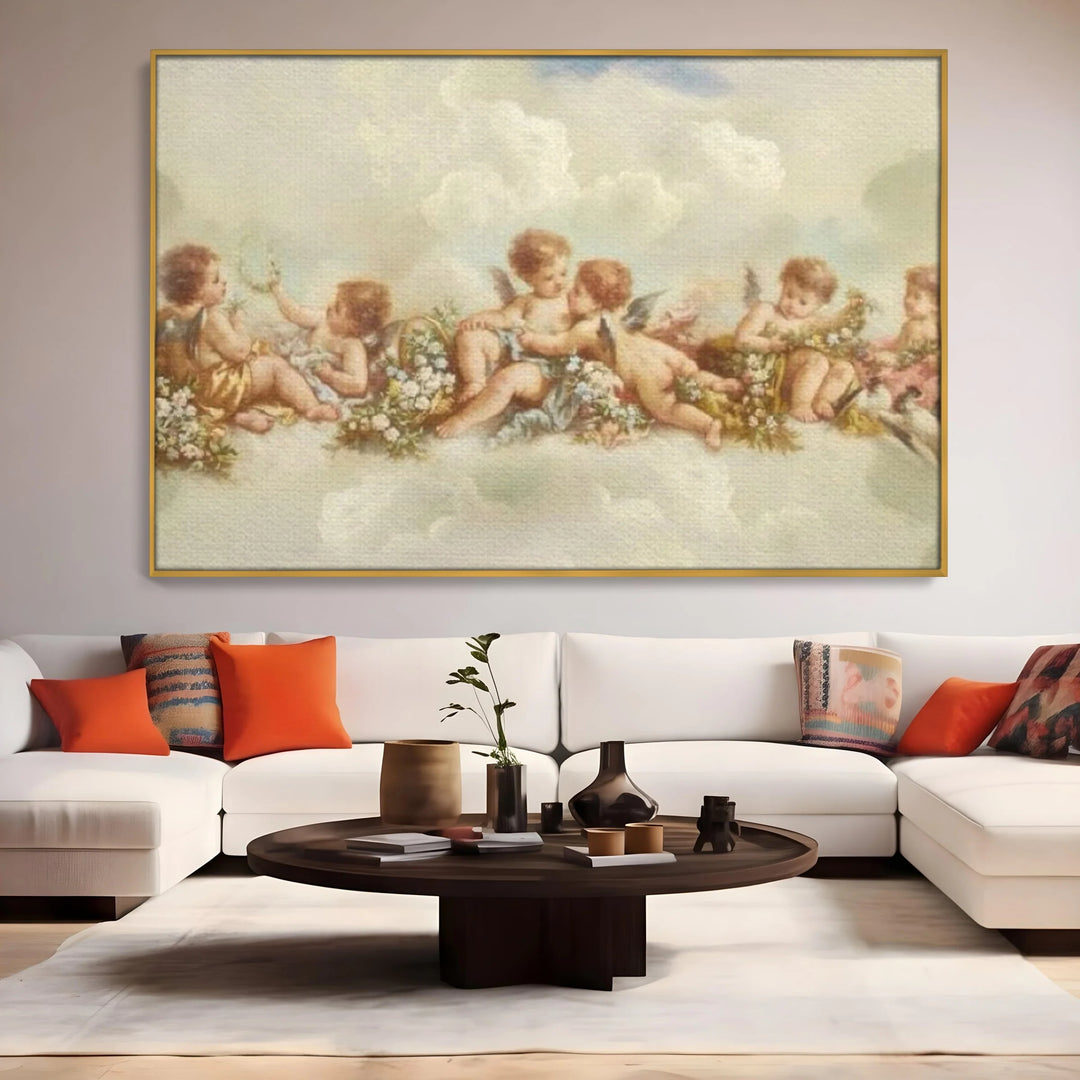 Tablou canvas cu pictura canvas cu ingerase pe nori, in rama de aluminiu auriu, pe perete intr-un living