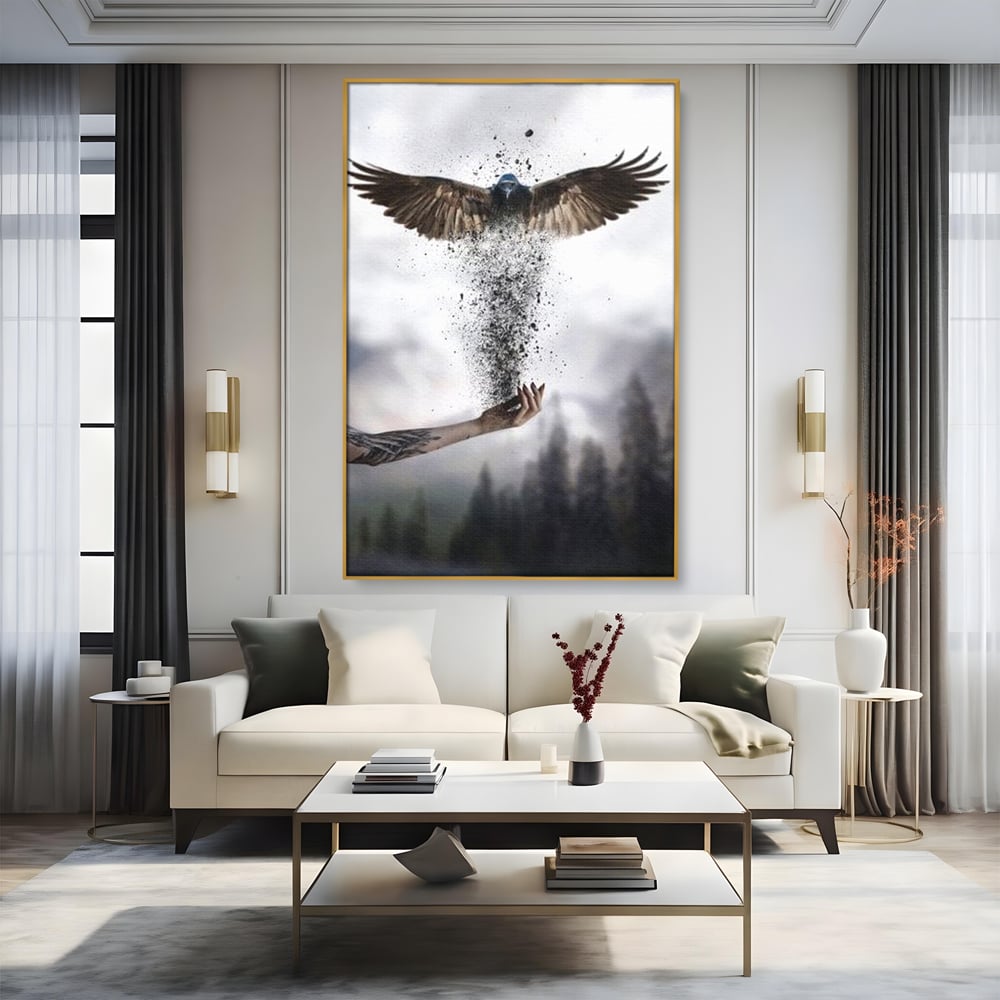 Tablou canvas cu tablou canvas cu pasare si mana din cenusa, in rama de aluminiu auriu, pe perete intr-un living