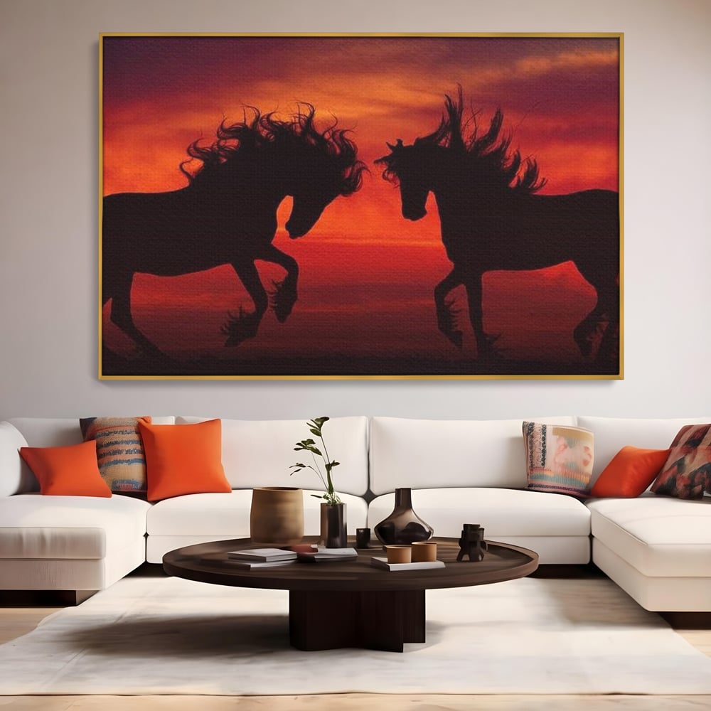 Tablou canvas cu tablou canvas cu siluete de cai in apus, in rama de aluminiu auriu, pe perete intr-un living