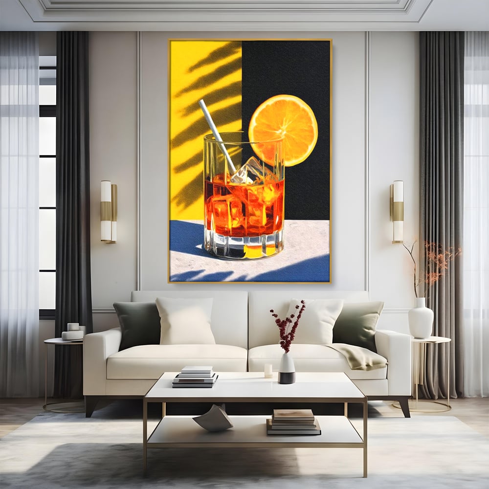 Tablou canvas cu ilustratie cu pahar de cocktail si portocala, in rama de aluminiu auriu, pe perete intr-un living