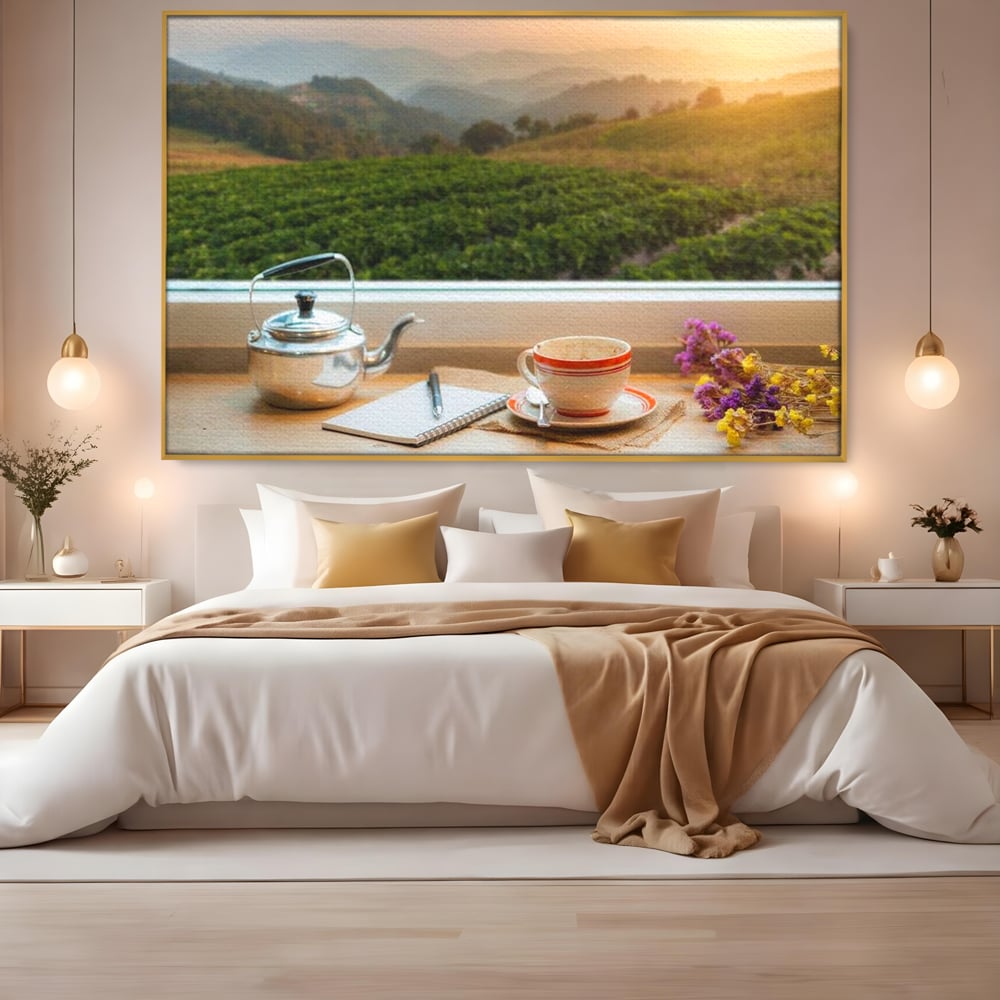 Tablou canvas cu tablou canvas cu peisaj matinal si ceainic pe pervaz, in rama de aluminiu auriu, pe perete intr-un dormitor