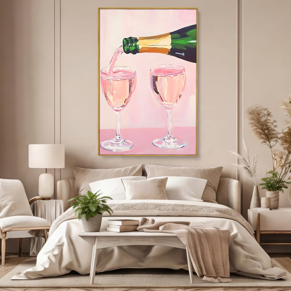 Tablou canvas cu pictura cu sticla si pahare de sampanie roz, in rama de aluminiu auriu, pe perete intr-un dormitor