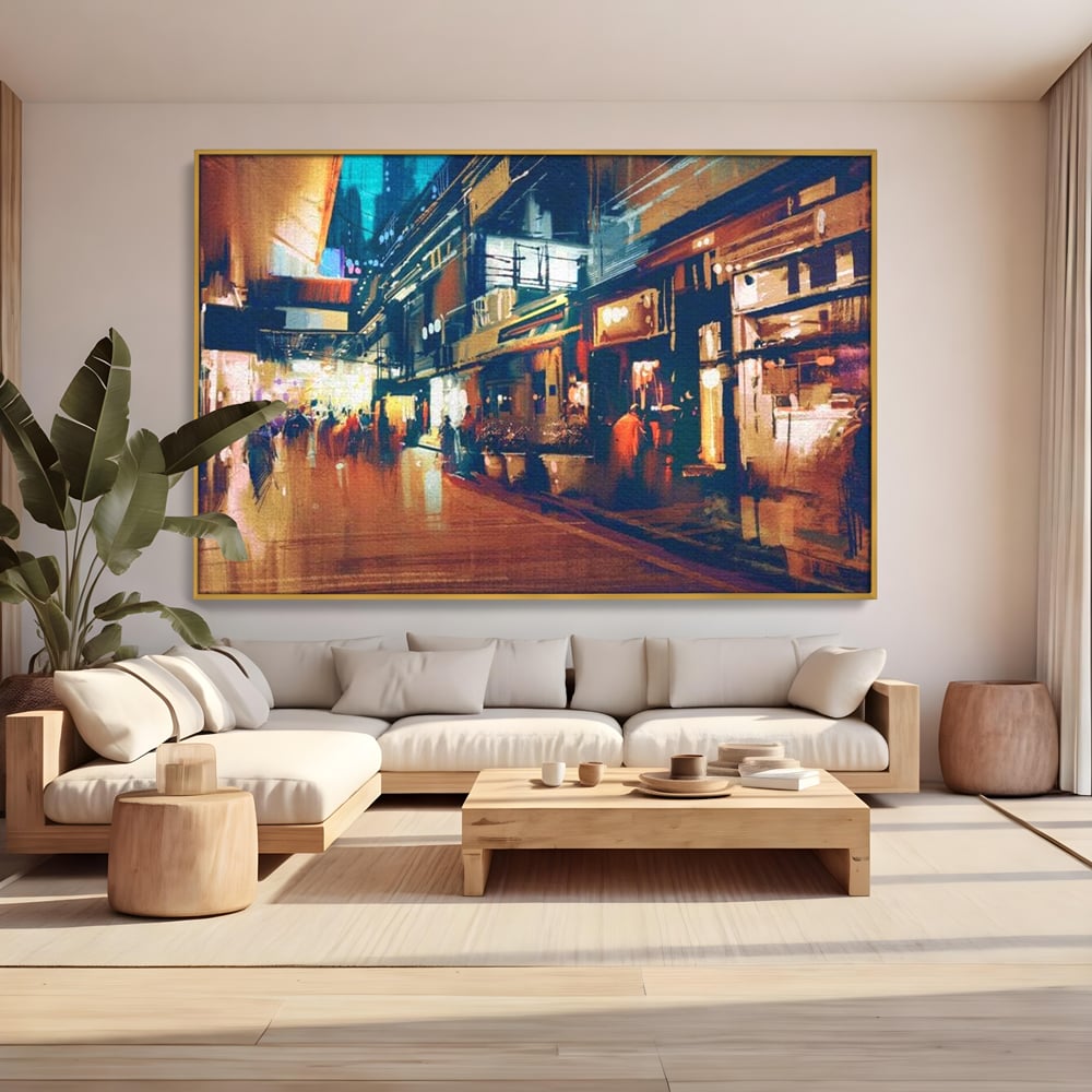 Tablou canvas cu pictura urbana cu strada luminata noaptea, in rama de aluminiu auriu, pe perete intr-un living