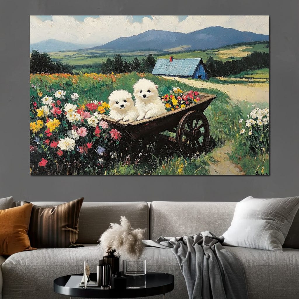 tablou canvas cu doi catelusi albi intr-o roaba plina cu flori, pe fundal idilic de campuri verzi si munti 