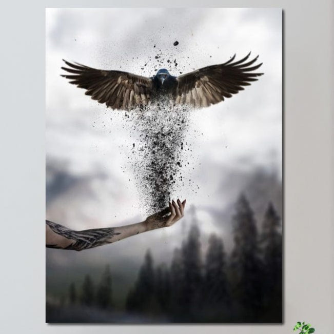 tablou canvas cu o pasare care renaste din cenusa in palma unei maini tatuate, pe fundal cu ceata si copaci