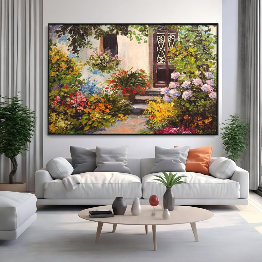 Tablou canvas cu tablou canvas cu alee florala si casa, in rama de aluminiu negru, pe perete intr-un living