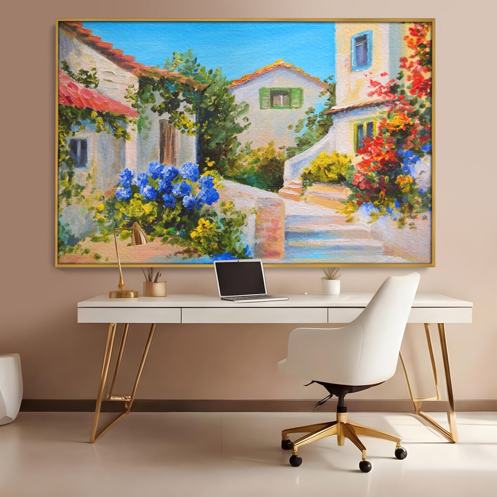 Tablou canvas cu pictura peisaj mediteranean cu case, in rama de aluminiu auriu, pe perete intr-un birou