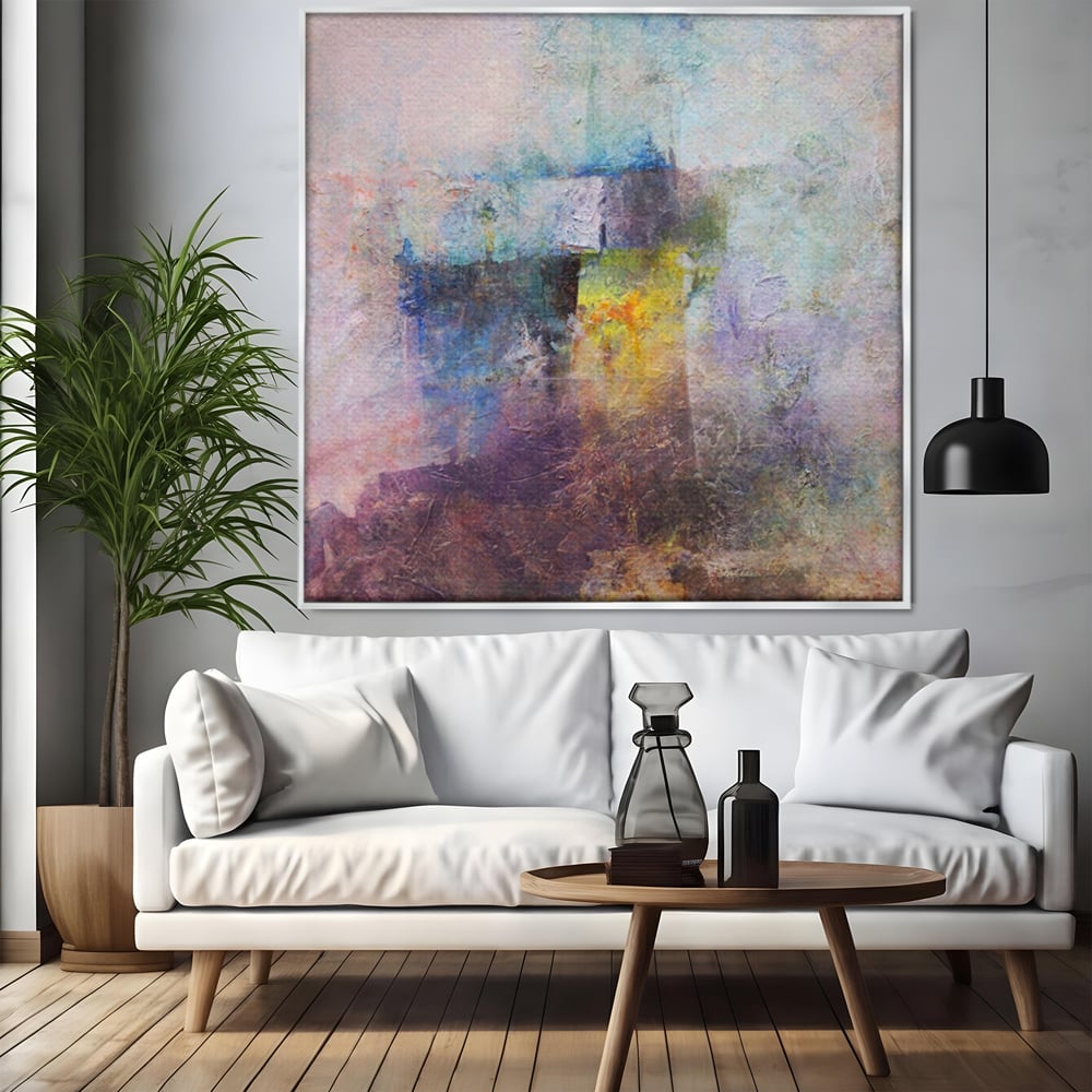 Tablou canvas cu pictura abstracta cu pete mov si albastre, in rama de aluminiu argintiu, pe perete intr-un living