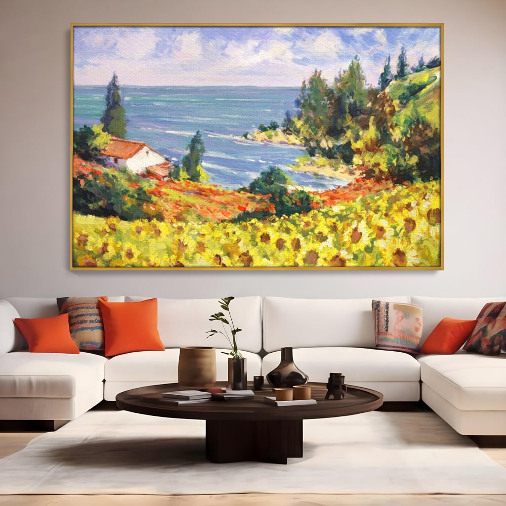 Tablou canvas cu pictura camp cu floarea soarelui si mare, in rama de aluminiu auriu, pe perete intr-un living