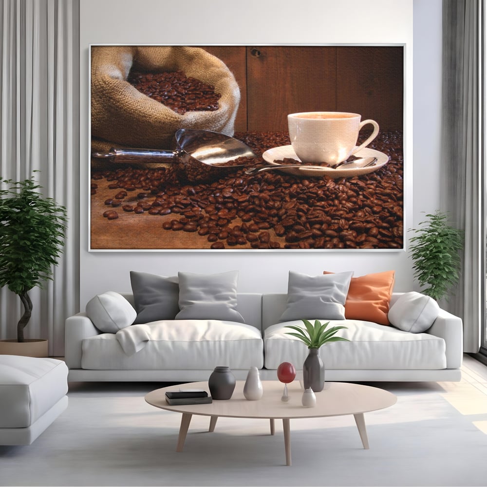 Tablou canvas cu tablou cu cana de cafea si sac de iuta, in rama de aluminiu argintiu, pe perete intr-un living