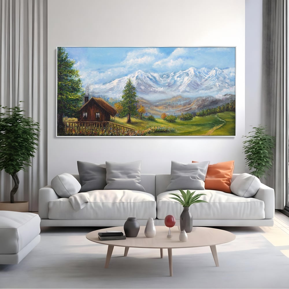Tablou canvas cu tablou canvas cu peisaj montan si cabana, in rama de aluminiu argintiu, pe perete intr-un living
