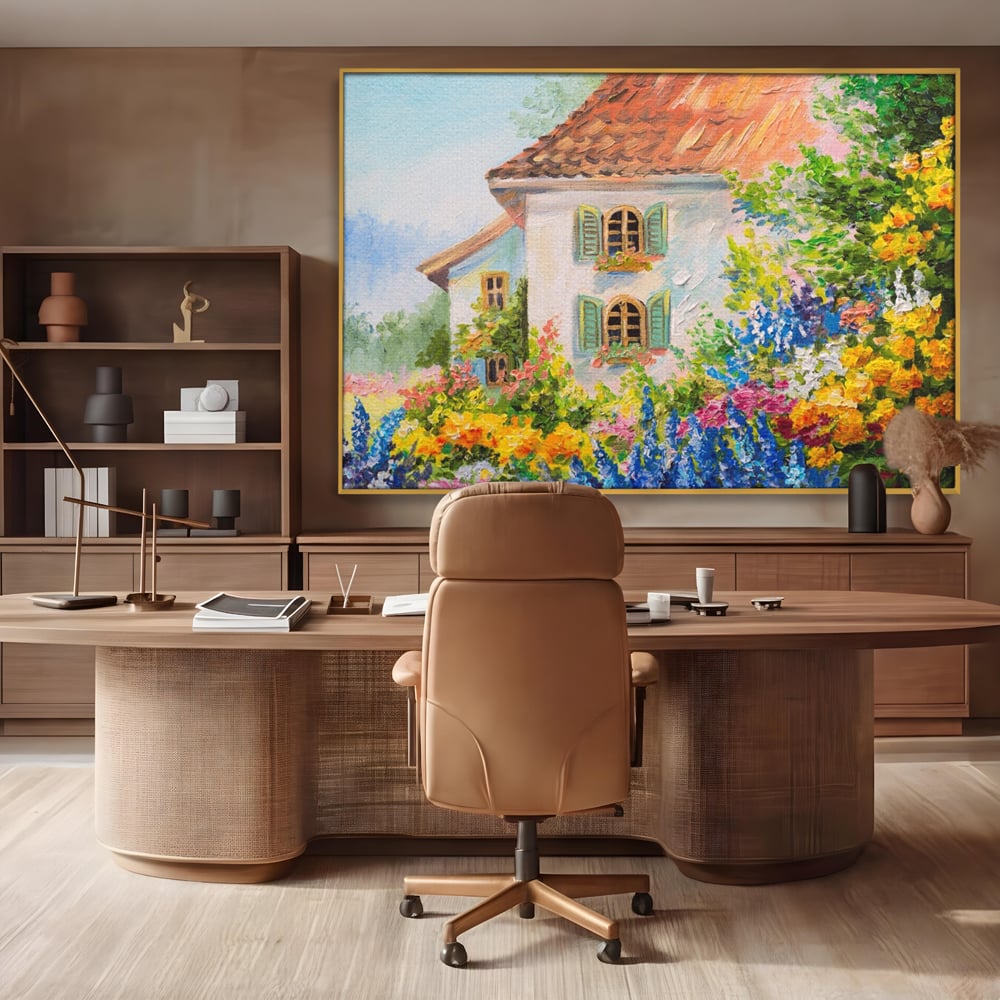 Tablou canvas cu pictura cu casa alba si flori, in rama de aluminiu auriu, pe perete intr-un birou