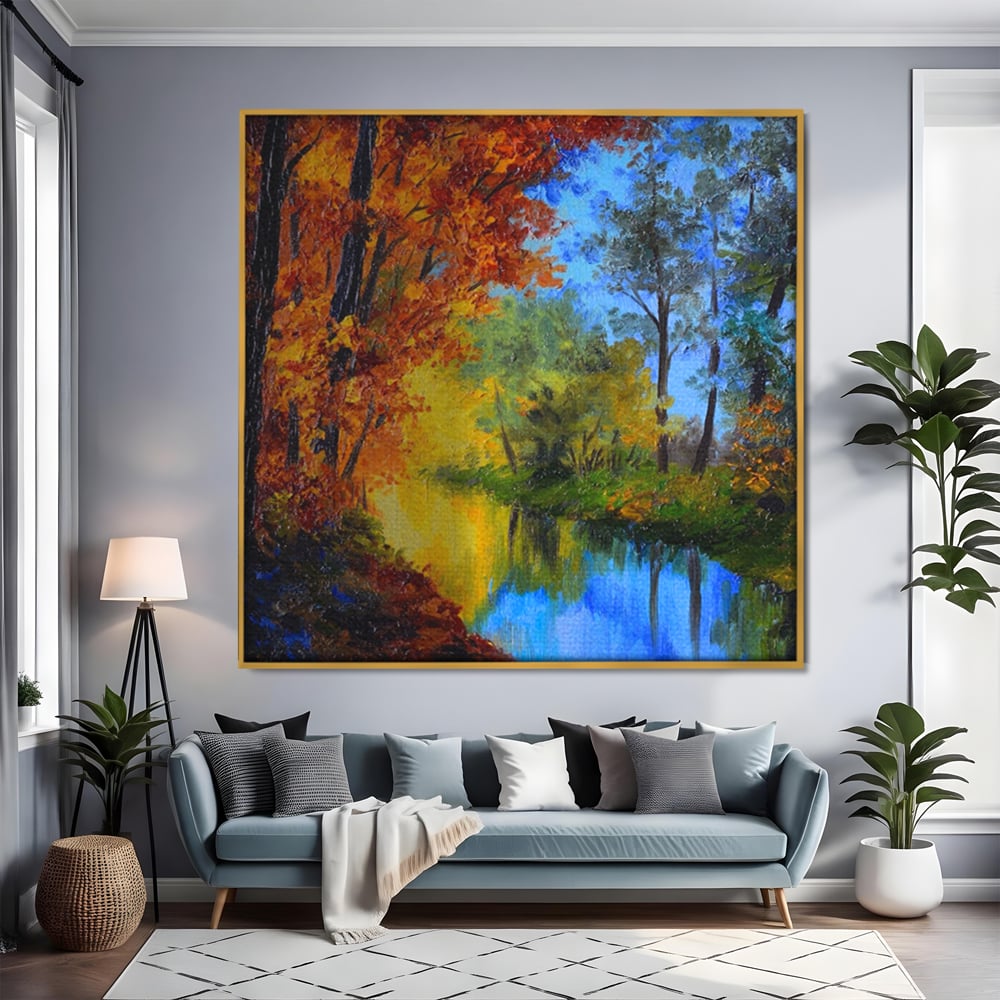 Tablou canvas cu pictura in ulei cu padure toamna si lac, in rama de aluminiu auriu, pe perete intr-un living