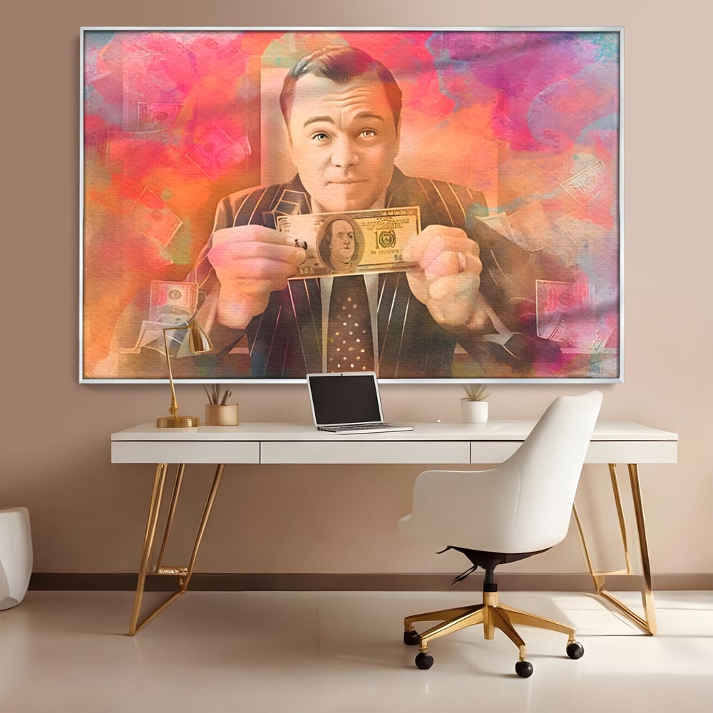 Tablou canvas cu tablou cu actorul leonardo dicaprio tinand bani, in rama de aluminiu argintiu, pe perete intr-un birou