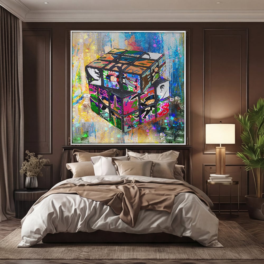 Tablou canvas cu pictura cub rubik cu monopol, in rama de aluminiu argintiu, pe perete intr-un dormitor