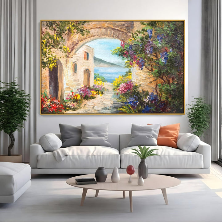 Tablou canvas cu pictura in ulei cu arcada de piatra si mare, in rama de aluminiu auriu, pe perete intr-un living