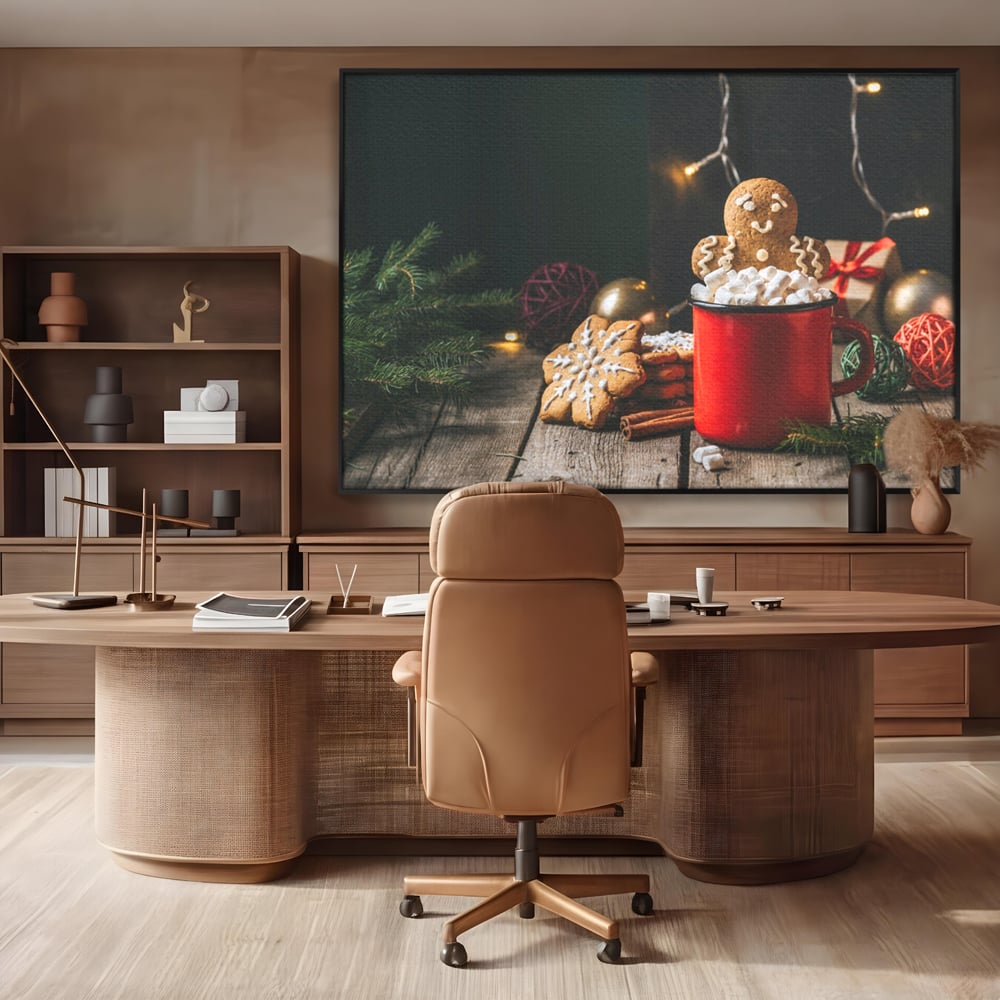 Tablou canvas cu tablou canvas cu turta dulce si cana rosie, in rama de aluminiu negru, pe perete intr-un birou