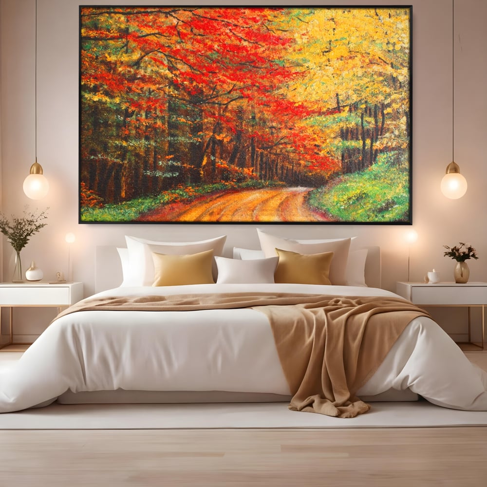 Tablou canvas cu pictura peisaj cu drum prin padure toamna, in rama de aluminiu negru, pe perete intr-un dormitor