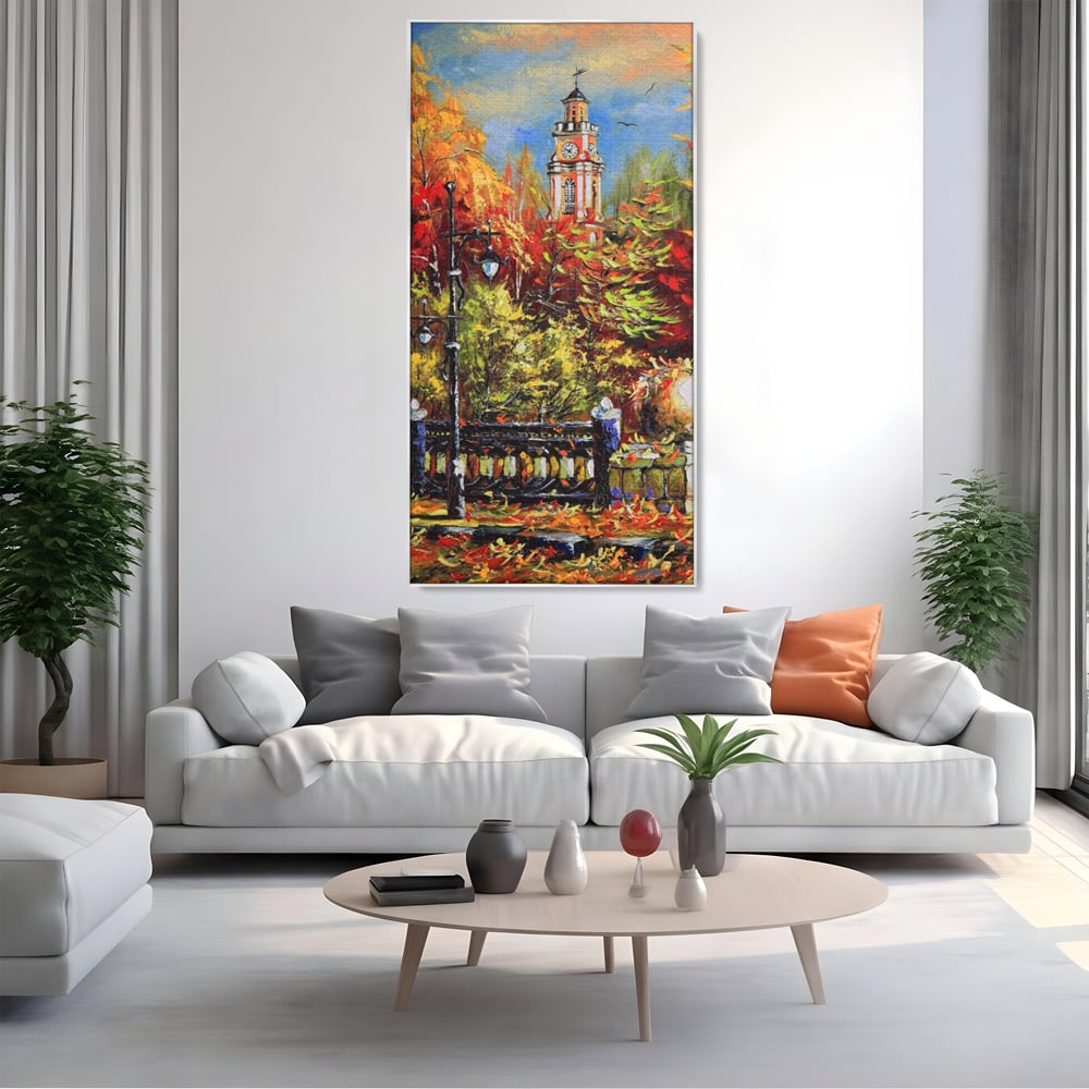 Tablou canvas cu pictura cu peisaj de toamna si turn cu ceas, in rama de aluminiu argintiu, pe perete intr-un living