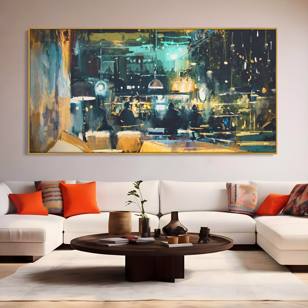 Tablou canvas cu pictura cu cafenea nocturna si lumini, in rama de aluminiu auriu, pe perete intr-un living