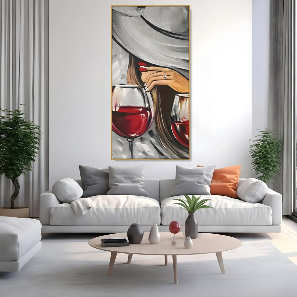 Tablou canvas cu tablou canvas cu femeie si vin rosu, in rama de aluminiu auriu, pe perete intr-un living