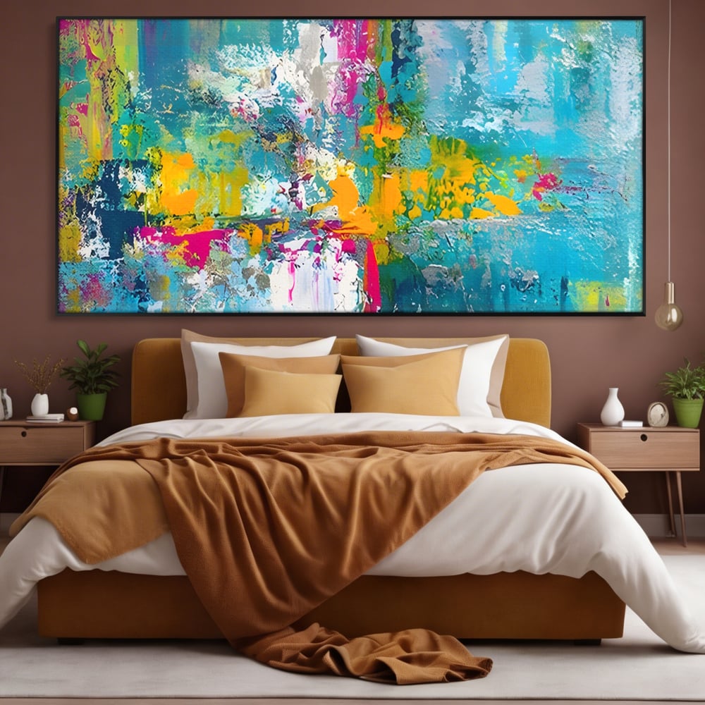 Tablou canvas cu pictura abstracta cu pete albastre si galbene, in rama de aluminiu negru, pe perete intr-un dormitor