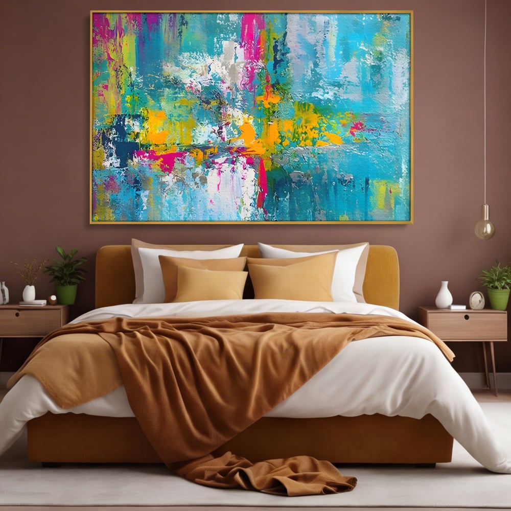 Tablou canvas cu pictura abstracta cu pete albastre si galbene, in rama de aluminiu auriu, pe perete intr-un dormitor