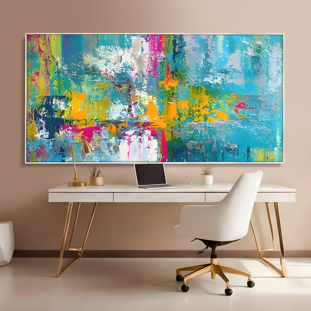 Tablou canvas cu pictura abstracta cu pete albastre si galbene, in rama de aluminiu argintiu, pe perete intr-un birou