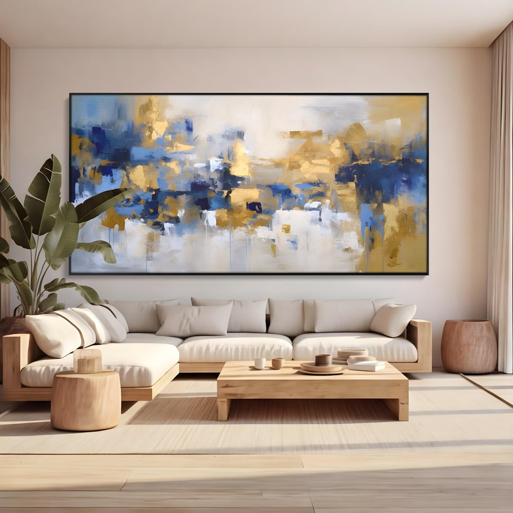 Tablou canvas cu tablou abstract cu pete aurii si albastre, in rama de aluminiu negru, pe perete intr-un living