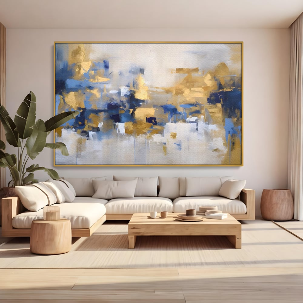 Tablou canvas cu tablou abstract cu pete aurii si albastre, in rama de aluminiu auriu, pe perete intr-un living