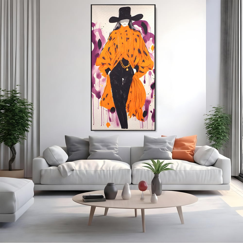 Tablou canvas cu ilustratie fashion cu femeie in costum portocaliu, in rama de aluminiu negru, pe perete intr-un living