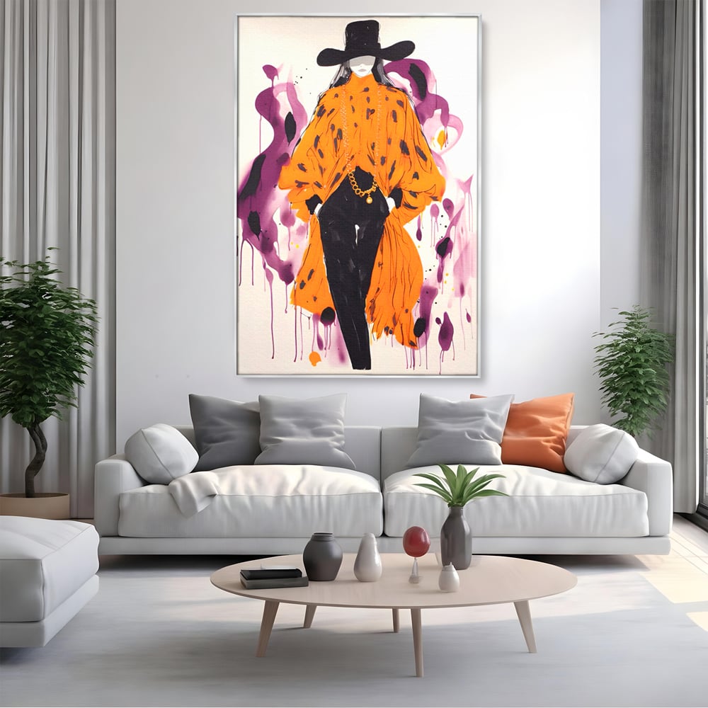 Tablou canvas cu ilustratie fashion cu femeie in costum portocaliu, in rama de aluminiu argintiu, pe perete intr-un living