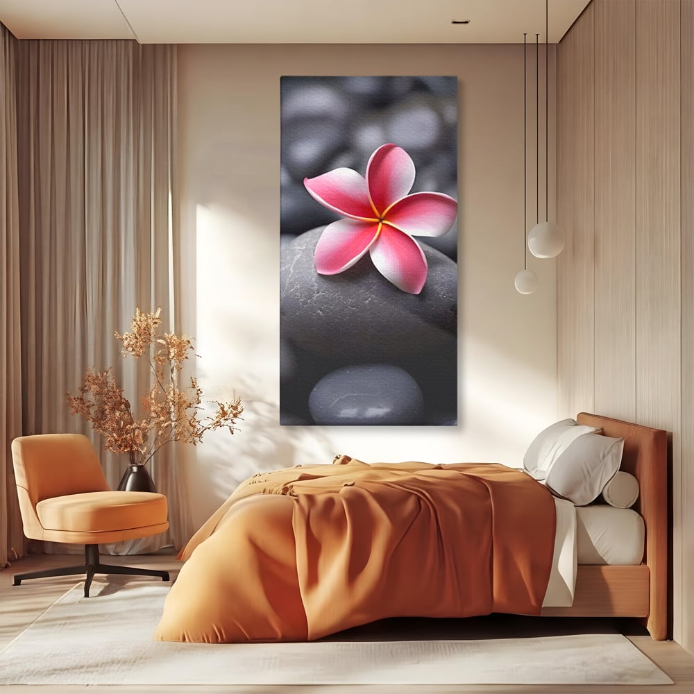 Tablou canvas cu floare roz pe pietre gri, fara rama, pe sasiu de lemn, pe perete intr-un dormitor