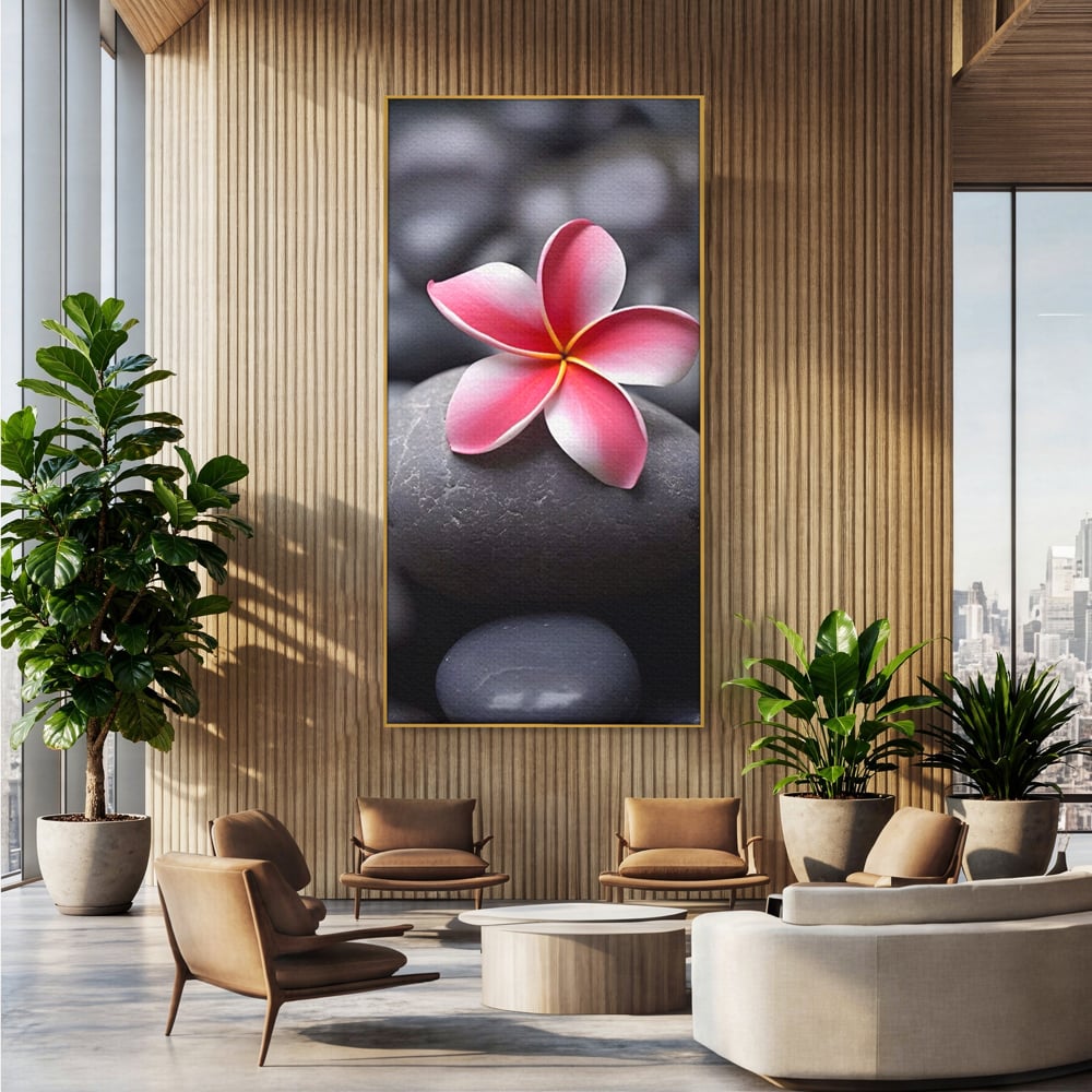 Tablou canvas cu floare roz pe pietre gri, in rama de aluminiu auriu, pe perete intr-un birou