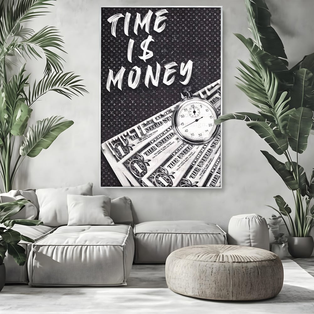 Tablou canvas cu tablou motivational cu bani si ceas, in rama de aluminiu argintiu, pe perete intr-un living