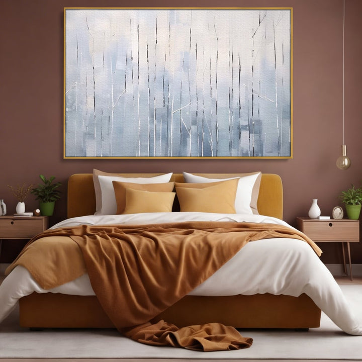 Tablou canvas cu tablou pictat cu trunchiuri subtiri pe fundal albastru, in rama de aluminiu auriu, pe perete intr-un dormitor