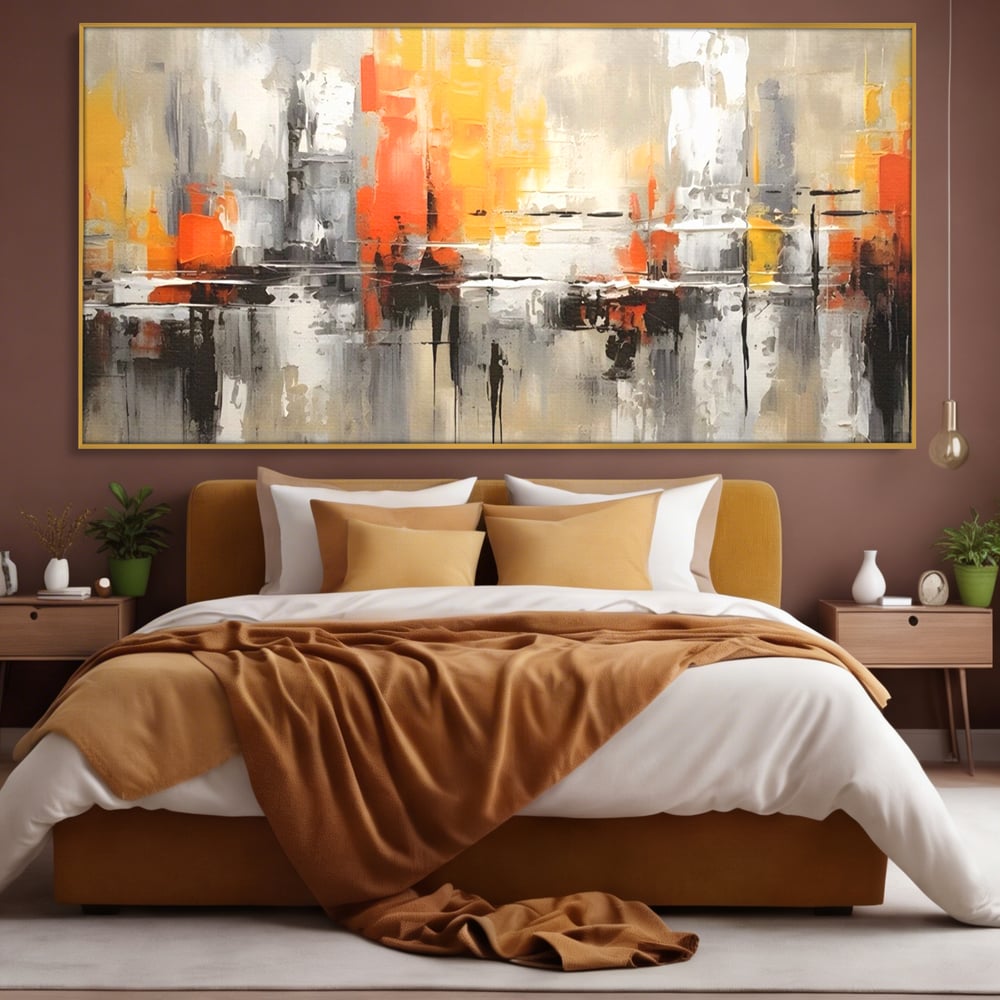 Tablou canvas cu pictura abstracta cu turnuri portocalii, in rama de aluminiu auriu, pe perete intr-un dormitor